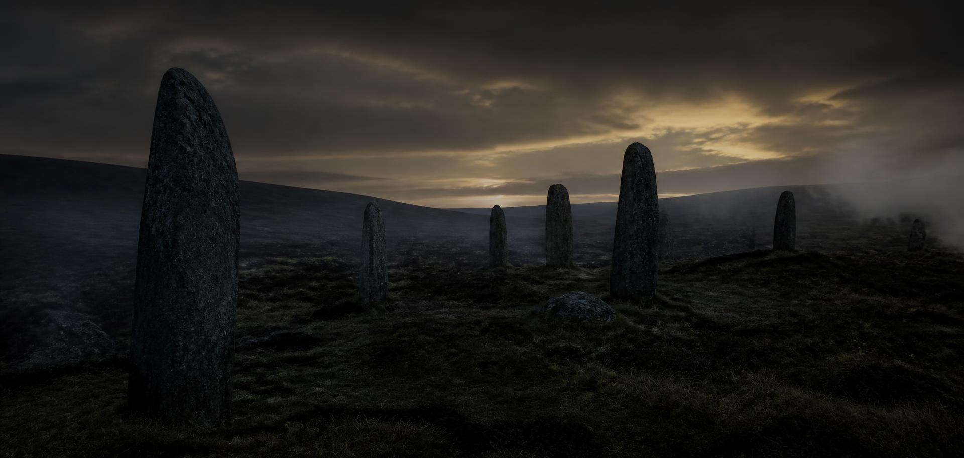 Standing stones on a dark Irish moor at dusk