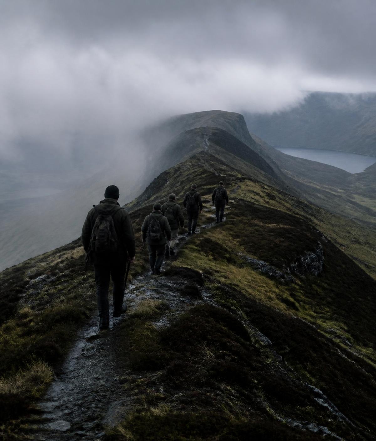 Men walking a highland ridge in mist